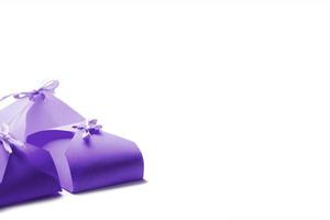 Small purple boxes for gifts on a white background.Place for text. Horizontal frame. photo