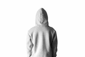 A man in a gray hoodie in a hood on a white background stands with his back. photo