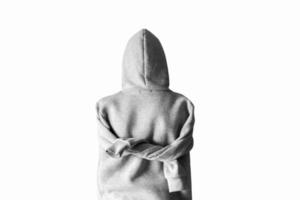 Teenager in a hoodie with a hood on a white background. Sleeves tied behind his back. photo