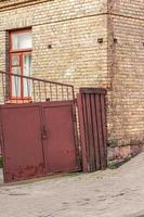 Old iron gate at a brick house. photo