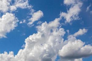 Clouds move against blue sky, weather background. photo