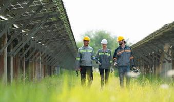 Engineering and technicians unloading repaired solar panels to be installed on the rows of solar cells lined up on hundreds of acres of grass photo