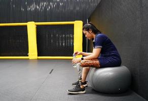 Young female with one prosthetic leg with the practice of using prosthetic legs to walk, exercise and and daily activities photo