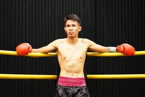 Muay Thai, The martial art of Thailand, Boxer sitting in the corner When the referee stops the fight in each round for the boxer to rest and the coach to introduce the fight in the next round. photo