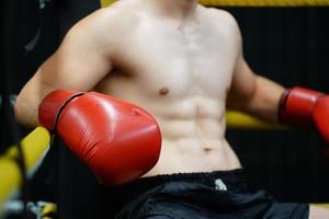 Muay Thai, The martial art of Thailand, Boxer sitting in the corner When the referee stops the fight in each round for the boxer to rest and the coach to introduce the fight in the next round. photo