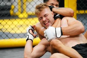 Mixed Martial Art, When the opponent is knocked down then use your hands to strangle your opponent's neck. making it difficult for the opponent to find a way to fight back photo