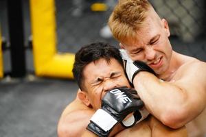 Mixed Martial Art, When the opponent is knocked down then use your hands to strangle your opponent's neck. making it difficult for the opponent to find a way to fight back photo