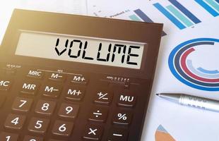 Word volume on calculator. Business and finance concept. photo