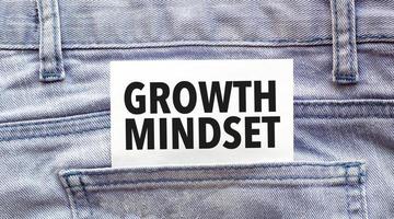 Text growth mindset on a white paper stuck out from jeans pocket. Business concept photo