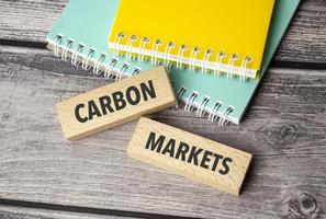 carbon markets symbol. Concept words return on assets on wooden blocks. photo