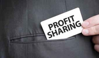 Card with profit sharing text in pocket of businessman suit. Investment and decisions business concept. photo