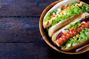 Hot dogs on wooden background photo