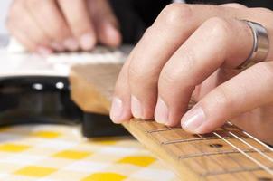 The fingers of the guitar photo