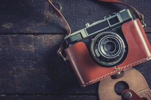 Old camera on wooden background photo
