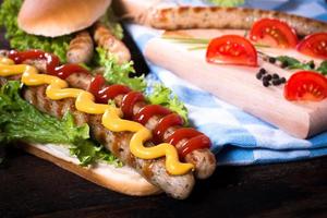 Ketchup and mustard on sausages photo