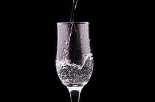 Water glass on black photo