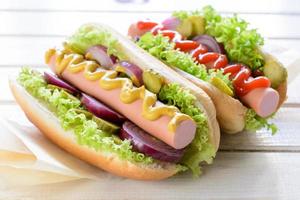 Hot dogs on wooden background photo