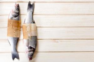 Bass fishes on wooden background photo
