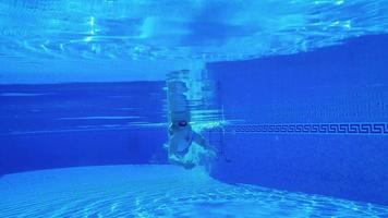 Underwater shooting as a man swims under the water video