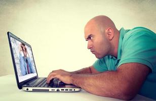 Man looking at laptop computer photo