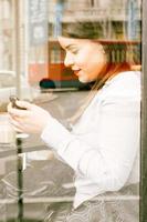 Female texting message in cafe photo