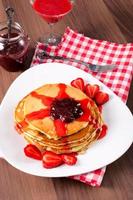 Strawberries jam and homemade pancakes photo