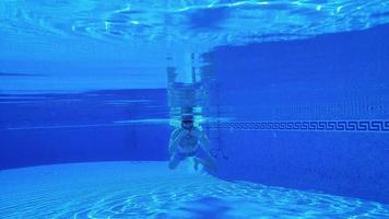 Underwater shooting as a man swims under the water video