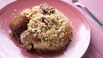 Lamb biryani meal in a bowl on table video