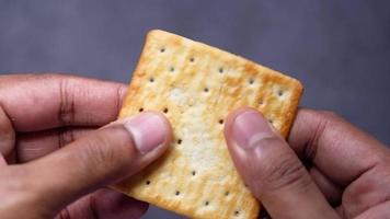 Man's hand breaking a biscuits video