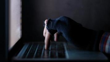 Hacker hand stealing data from laptop video