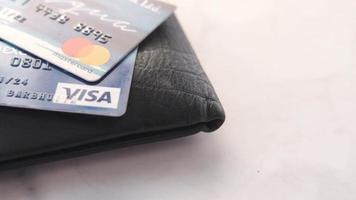 close up of credit cards and a wallet on white background video