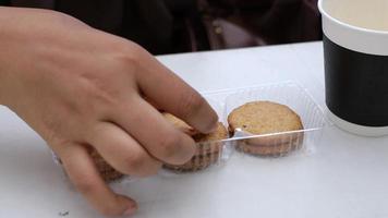 Hand pick cookies and tea on table video