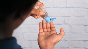 Close up of man hand using sanitizer gel isolated on black video