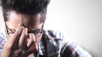 Young man suffering headache isolated on white video