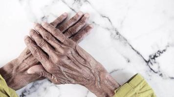 a nervous senior woman hand on table video