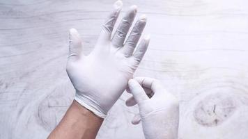 Man doctor wears medical gloves, close up video