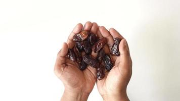 top view of many date fruit on hand on white background video