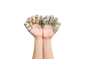 Isolated image of rolled up dollar banknotes on female fingers. Profit concept photo