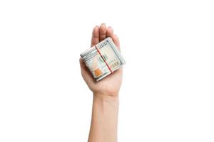 Top view of dollar bills in tubes in female hand on white isolated background. Business concept photo