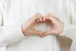 heart with hands. the girl is holding hands in the shape of the heart photo