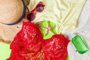 Woman summer outfit top view on color background. Fashion vacations concept photo