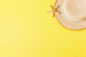yellow retro straw hat with seastar top view with copy space. summer concept on yellow background photo