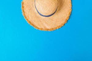 yellow retro straw hat top view with copy space. summer concept on blue background photo