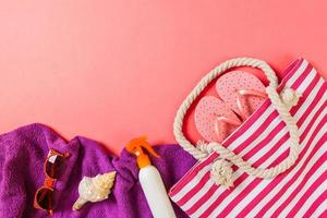 Summer bag background with copy space. Flat lay photo on color table, travel concept. Free space for text, mock-up