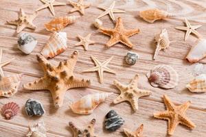 Starfish and seashells background on a wooden table, top view, flat lay photo