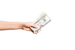 Female hand giving money on white isolated background. Top view of dollar banknotes. Bribe concept. Debt and loan concept photo