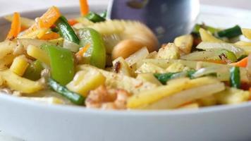 slow motion of eating fresh vegetable salad bowl on table video