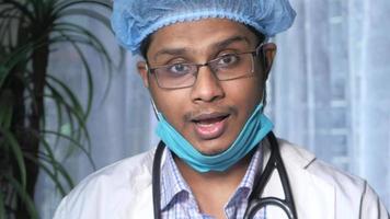 young asian doctor talking to camera in video chat