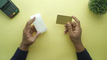 holding a credit card and long roll paper video