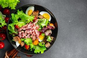 meat salad, bacon, egg, crouton, lettuce, salad dressing vinaigrette  Vosges salad Lorraine cuisine  meal food snack on the table copy space food background rustic top view photo